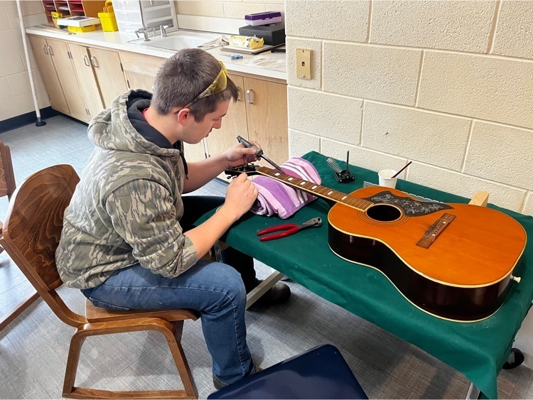 Taylor working on his guitar 